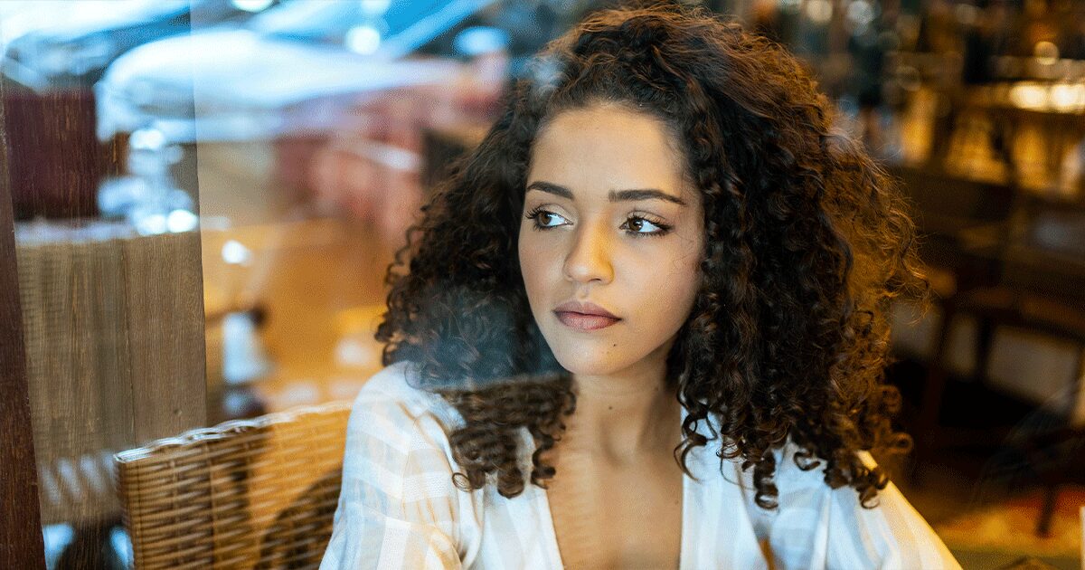 Woman thoughtfully considering why an ultrasound is important before taking the abortion pill.