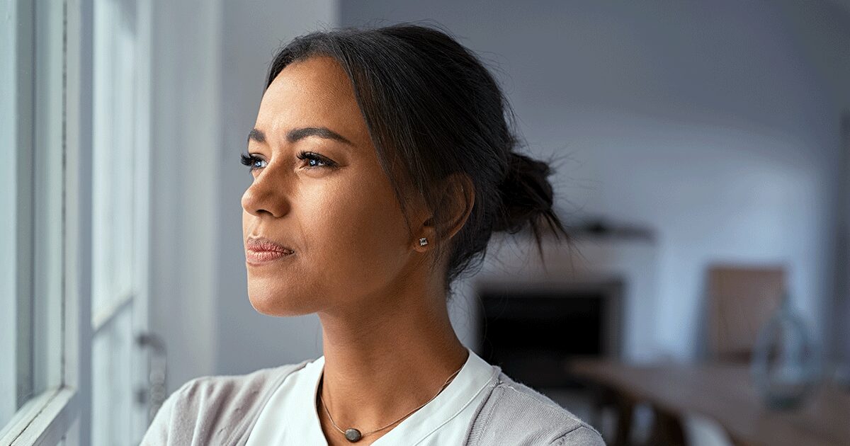 Thoughtful woman considering what questions to ask about abortion after an unexpected pregnancy.